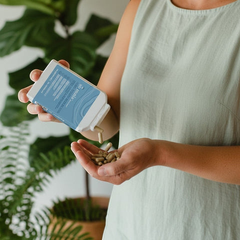 Bionobo so:mnia capsules being poured from a white bottle into a hand. Natural supplement.