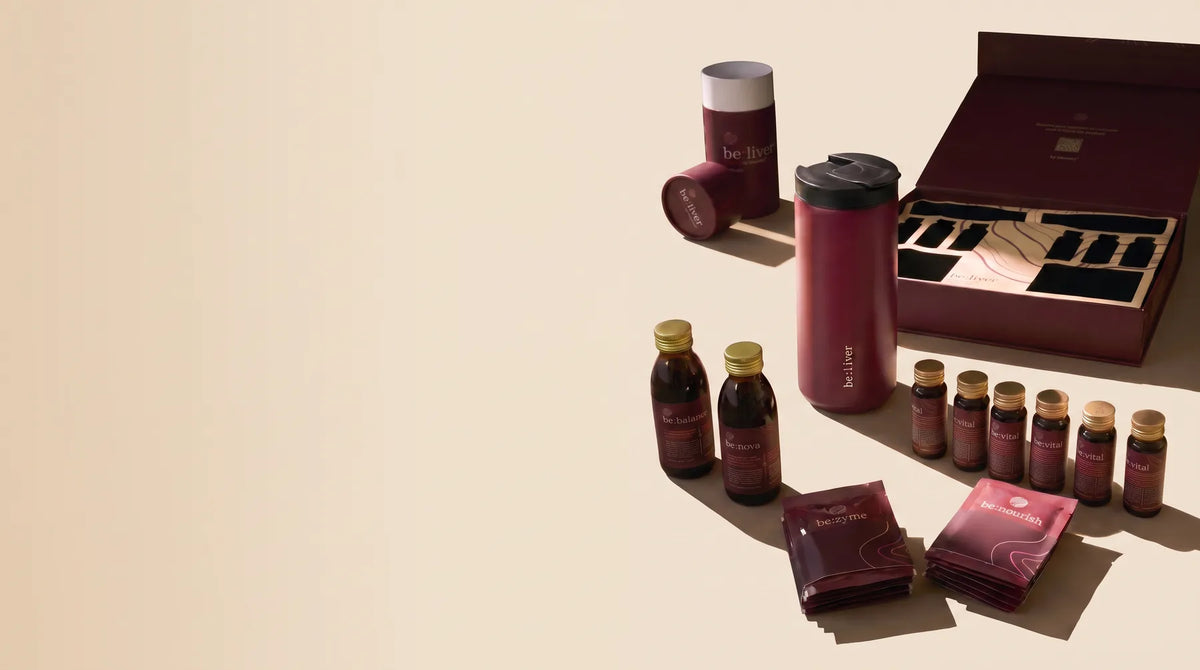 The be:liver kit with bottles, sachets and an open presentation box on a cream surface.